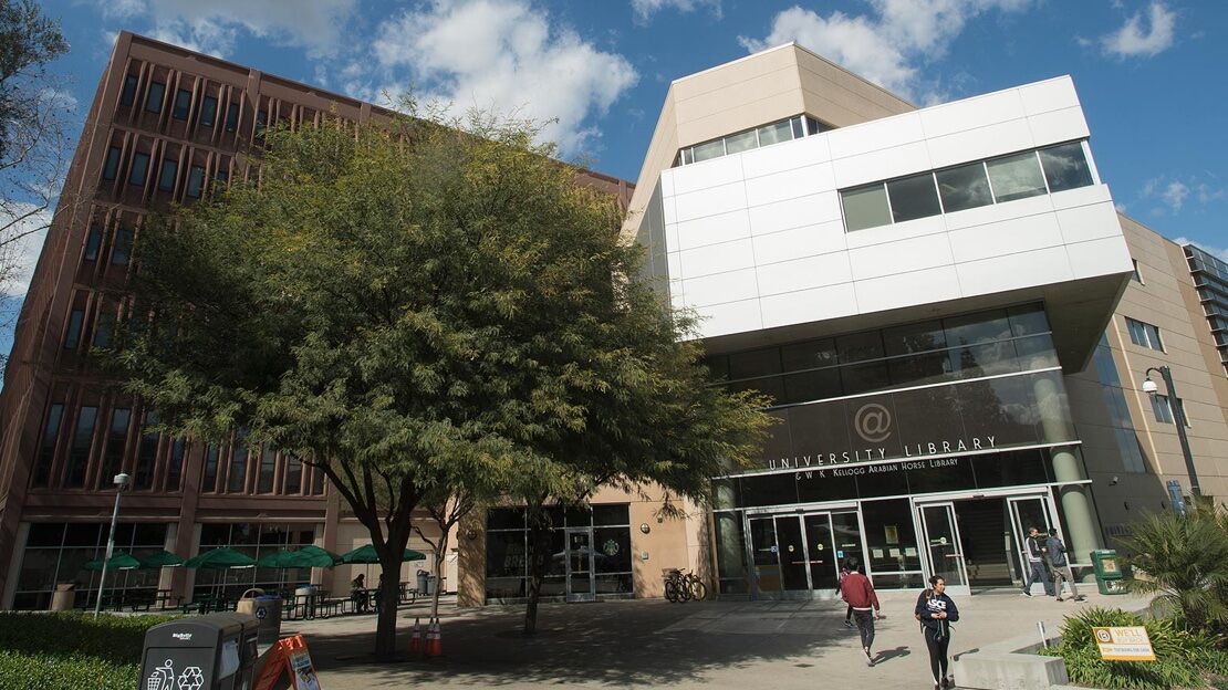 A modern building at the university with students milling about 
