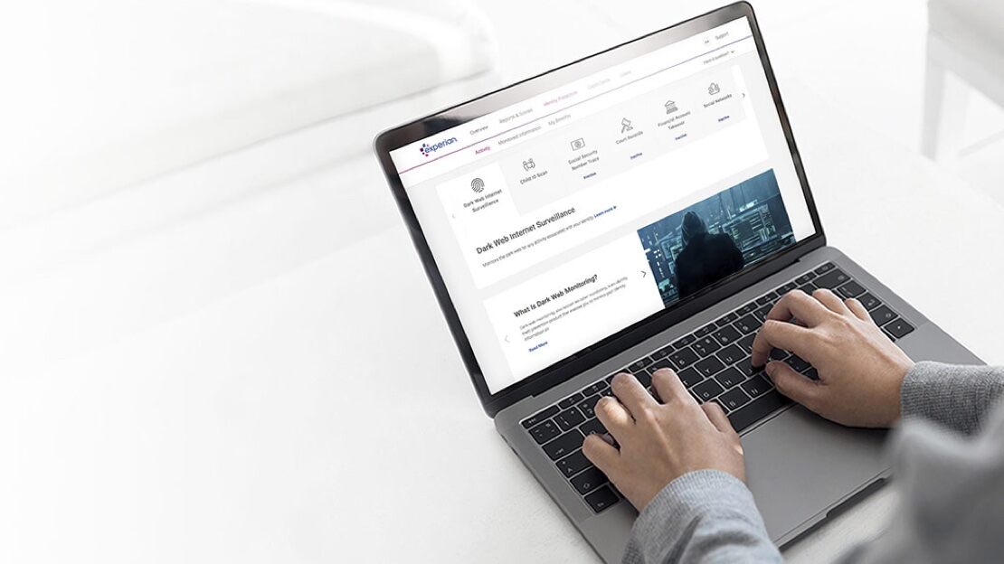 An overview of an open laptop with the Experian web page visible