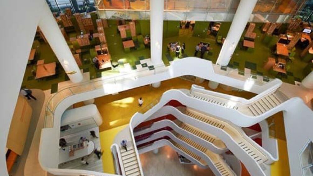 A long winding modern staircase inside an office building