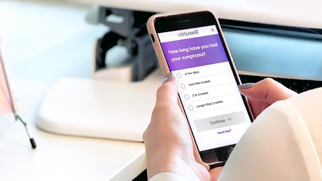  A woman holds a mobile phone open to a Health Partners app