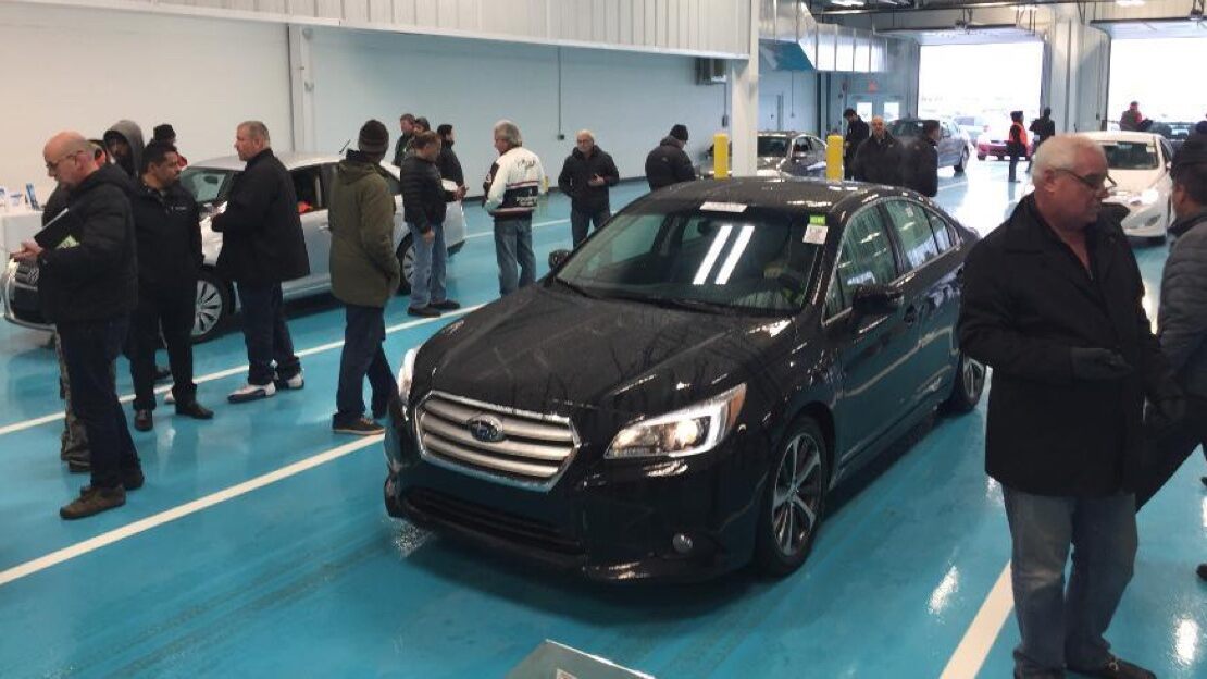 People at a KAR Auction event milling around cars