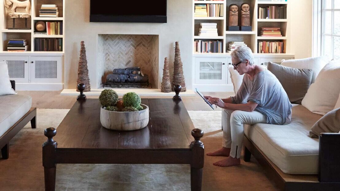 A view of a Royal Bank of Scotland (RBS) customer sits in her home using a tablet to access her account