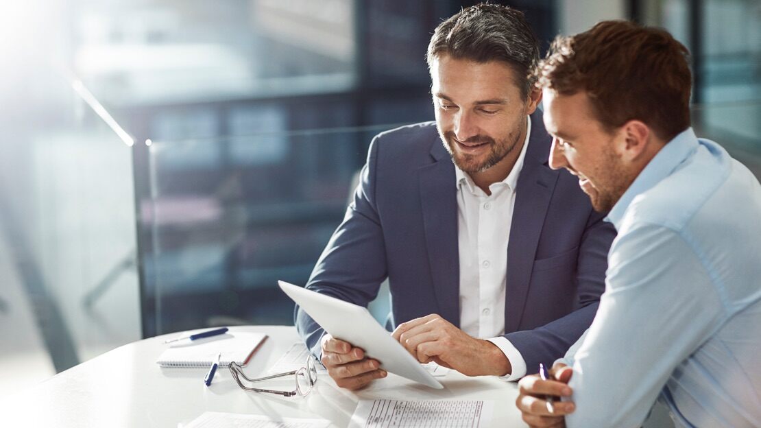 Two ServiceNow customers work together on a tablet